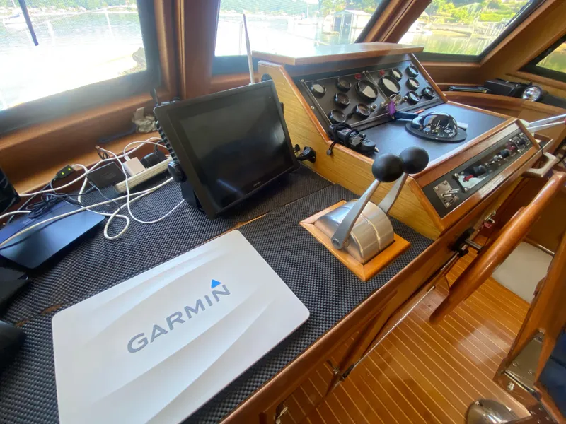 Slide: The Image of Cockpit of 1982 C & L Sea Ranger with Garmin navigation system and control panel. - 55