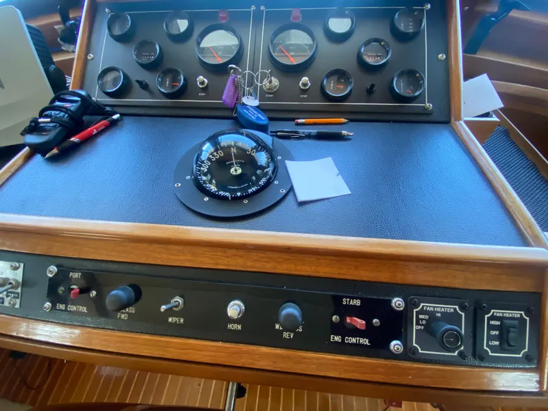 Slide: The Image of Control panel of a 1982 C & L Sea Ranger boat with compass and gauges. - 56
