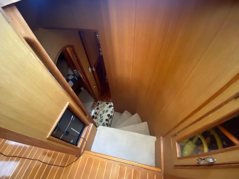 Slide: The Image of Interior view of 1982 C & L Sea Ranger, featuring wooden stairs and cabin hallway. - 64