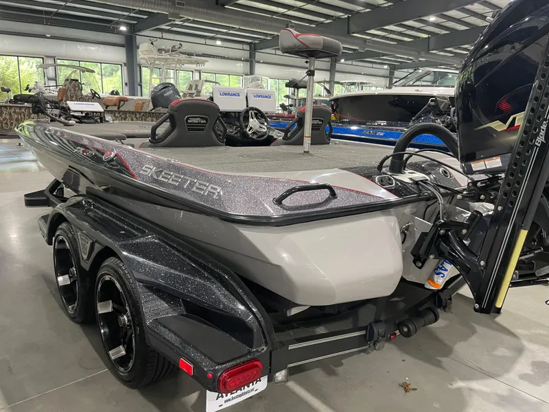 Slide: The Image of 2020 Skeeter FXR 21 Limited bass boat in showroom, rear view. - 10