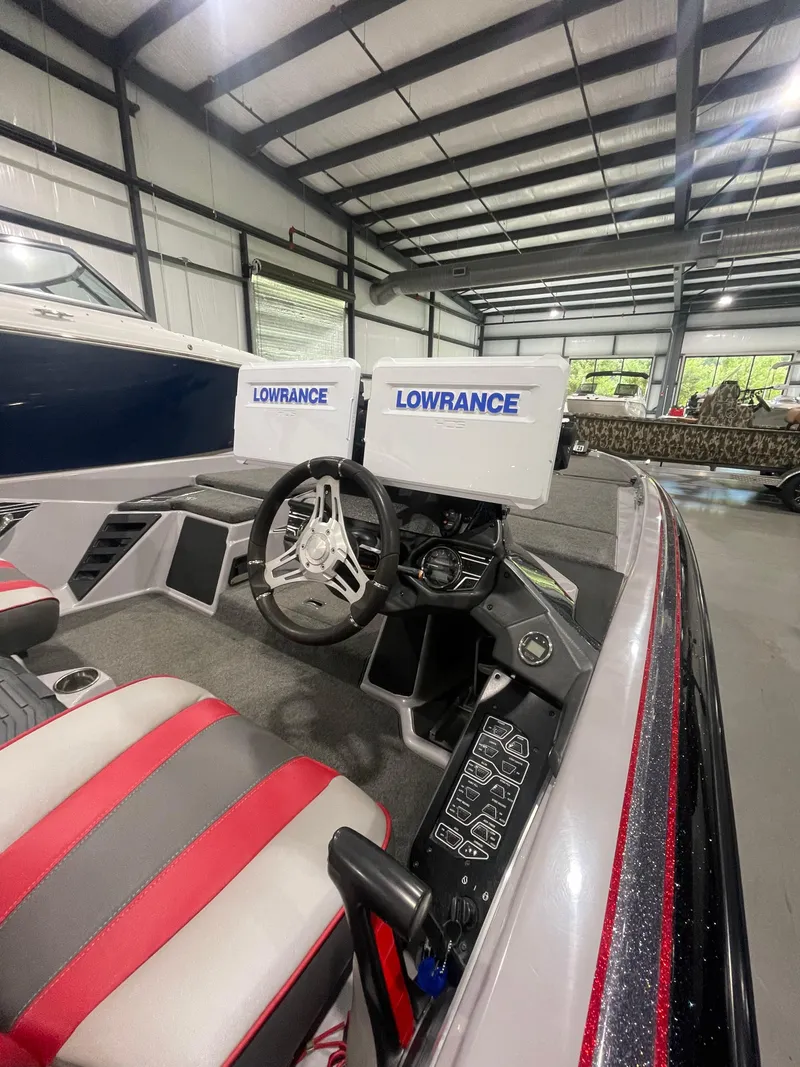 Slide: The Image of 2020 Skeeter FXR 21 Limited boat interior with Lowrance displays and steering wheel in a showroom. - 4