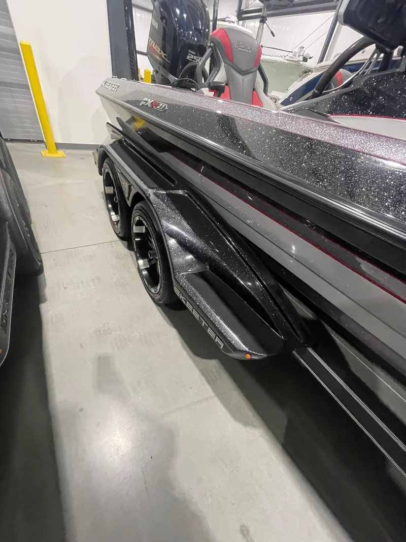 Slide: The Image of 2020 Skeeter FXR 21 Limited boat on trailer, showcasing sleek design and dual wheels. - 5