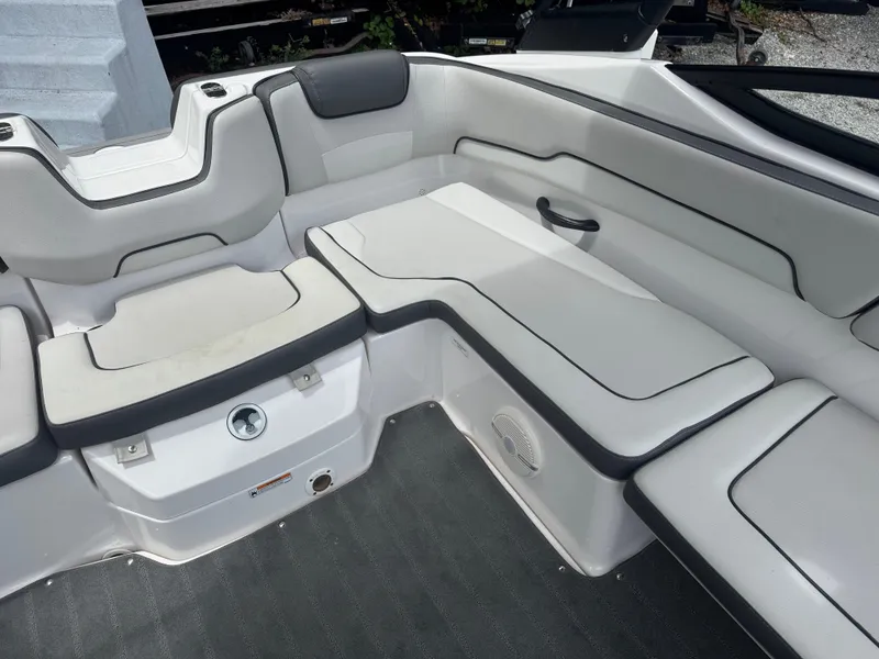 Slide: The Image of 2023 Yamaha AR190 boat interior with cushioned seating and sleek design. - 10