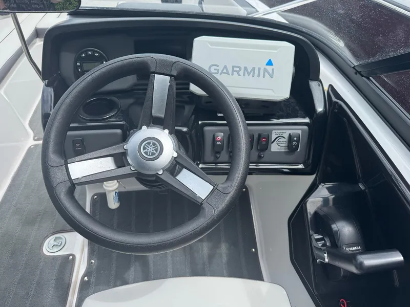 Slide: The Image of 2023 Yamaha AR190 boat dashboard with Garmin navigation system and steering wheel. - 13