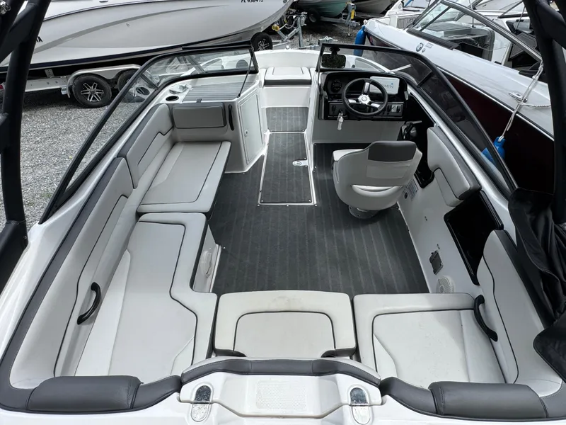 Slide: The Image of 2023 Yamaha Boats AR190 interior with spacious seating and modern dashboard. - 2