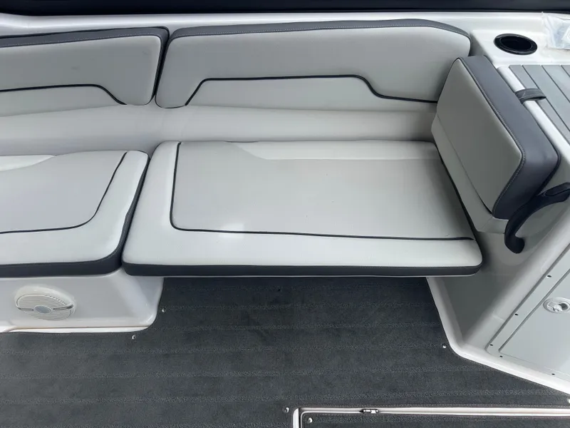 Slide: The Image of 2023 Yamaha AR190 boat interior seating with gray upholstery and cup holder. - 9