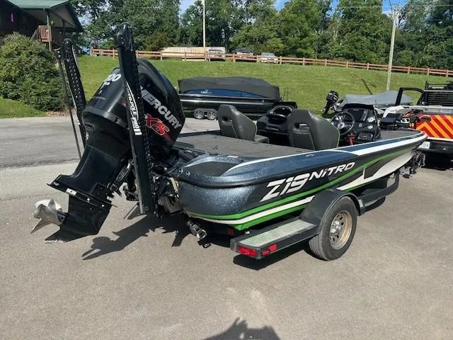 Slide: The Image of 2018 Nitro Z19 boat with Mercury engine on trailer, parked outdoors. - 3
