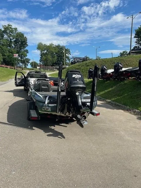 Slide: The Image of 2018 Nitro Z19 boat with 200 HP motor on trailer, parked on sunny day. - 7