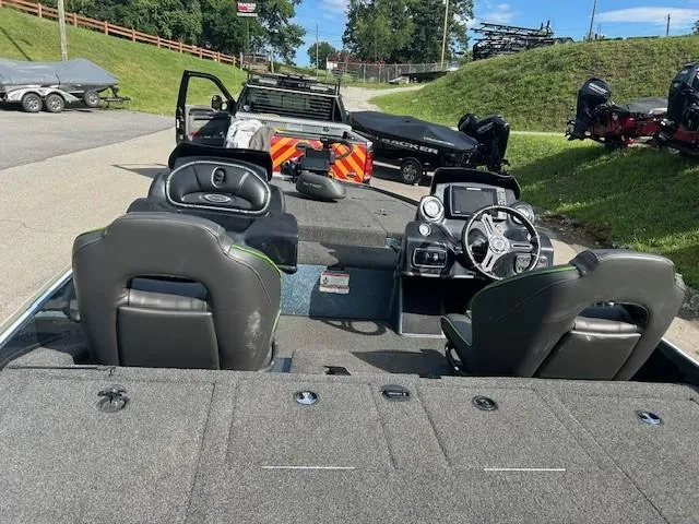 Slide: The Image of 2018 Nitro Z19 boat interior with dual seats and steering wheel, parked outdoors. - 8