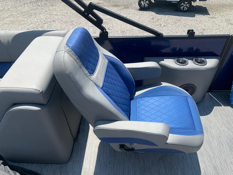 Slide: The Image of Blue and gray captain's chair on 2021 Bennington 24 LSR boat, featuring cup holders. - 10