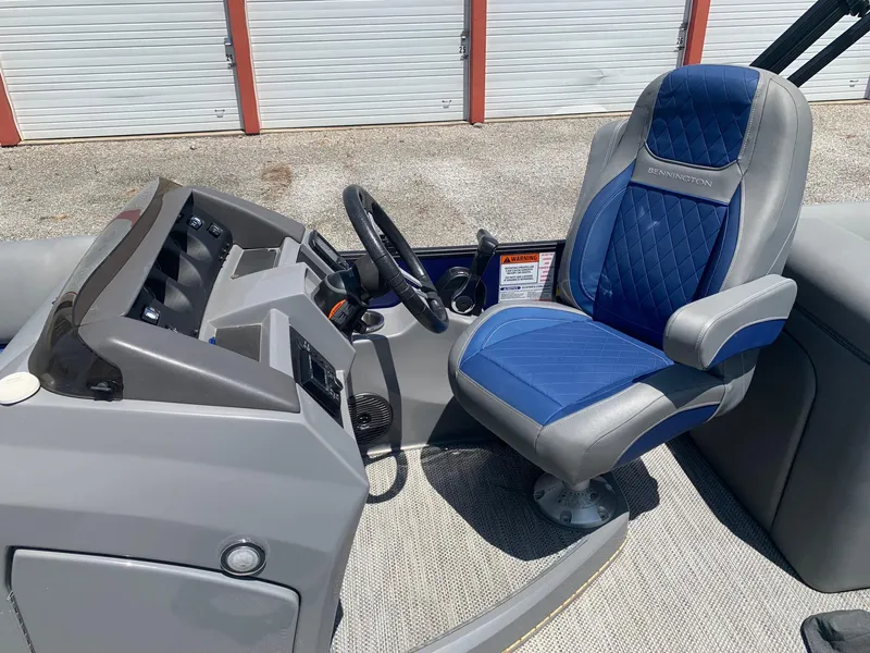 Slide: The Image of 2021 Bennington 24 LSR boat cockpit with blue and gray captain's chair. - 11