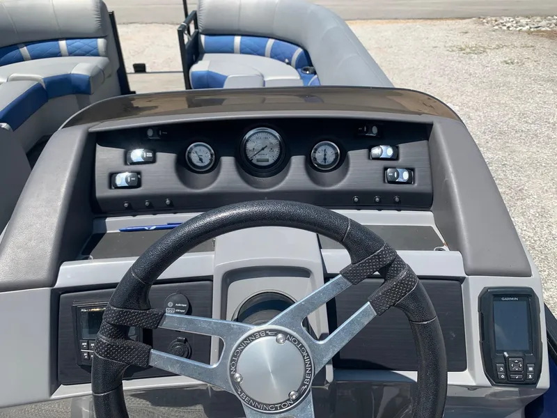 Slide: The Image of 2021 Bennington 24 LSR boat dashboard with steering wheel and gauges. - 14