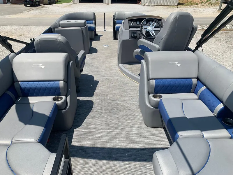 Slide: The Image of 2021 Bennington 24 LSR pontoon boat interior with gray and blue seating. - 5