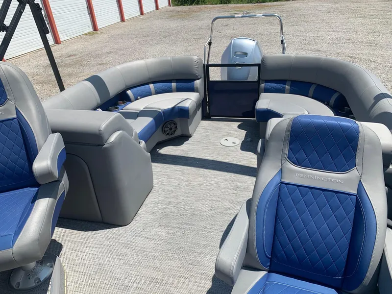 Slide: The Image of 2021 Bennington 24 LSR pontoon boat interior with blue and gray seating. - 6