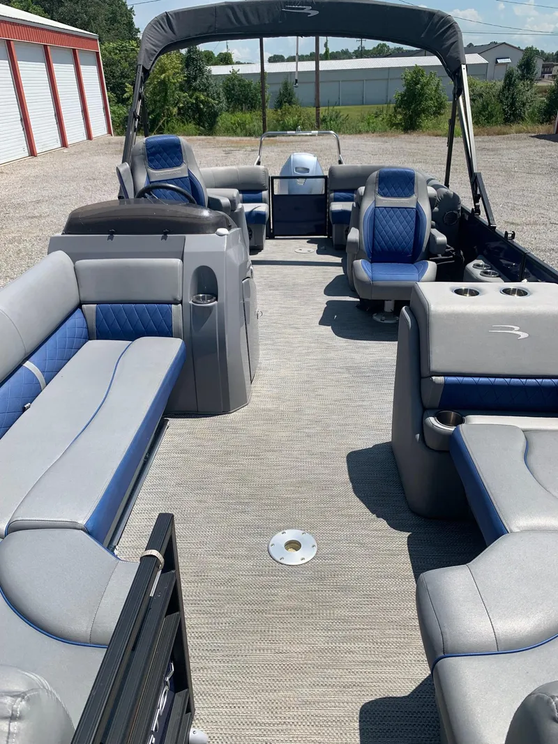 Slide: The Image of 2021 Bennington 24 LSR pontoon boat interior with blue and gray seating. - 7