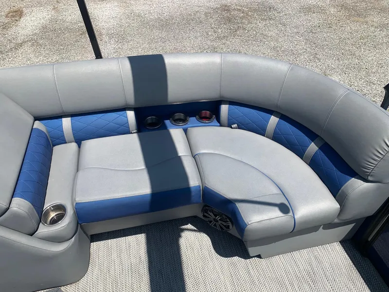 Slide: The Image of Luxurious seating on 2021 Bennington 24 LSR pontoon boat with blue and gray upholstery. - 8