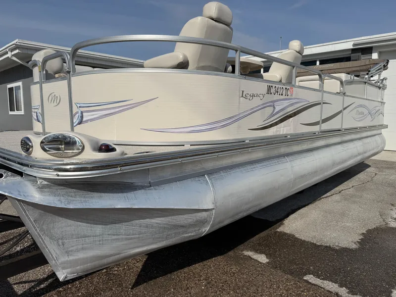 Slide: The Image of 2006 Manitou 24 Legacy pontoon boat with sleek design and comfortable seating. - 11