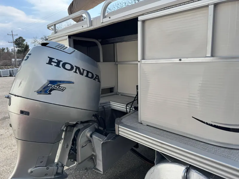 Slide: The Image of 2006 Manitou 24 Legacy boat with Honda four-stroke outboard motor. - 12