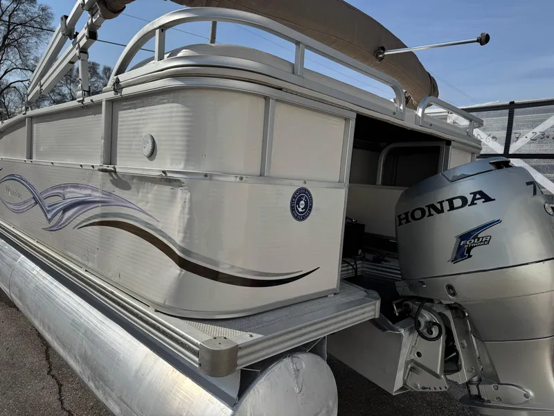 Slide: The Image of 2006 Manitou 24 Legacy pontoon boat with Honda outboard motor. - 14