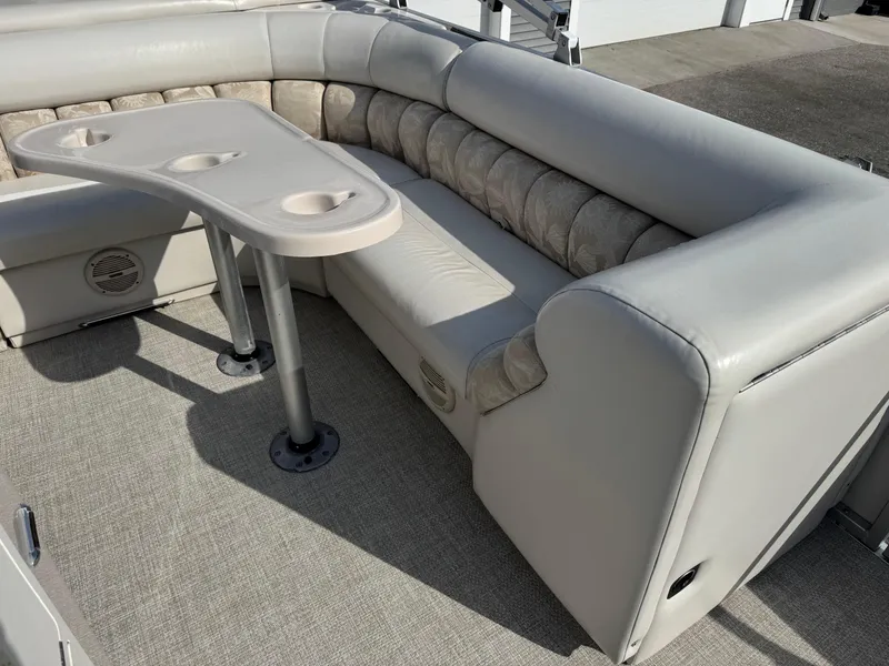 Slide: The Image of Luxurious seating area on a 2006 Manitou 24 Legacy pontoon boat with cupholder table. - 6