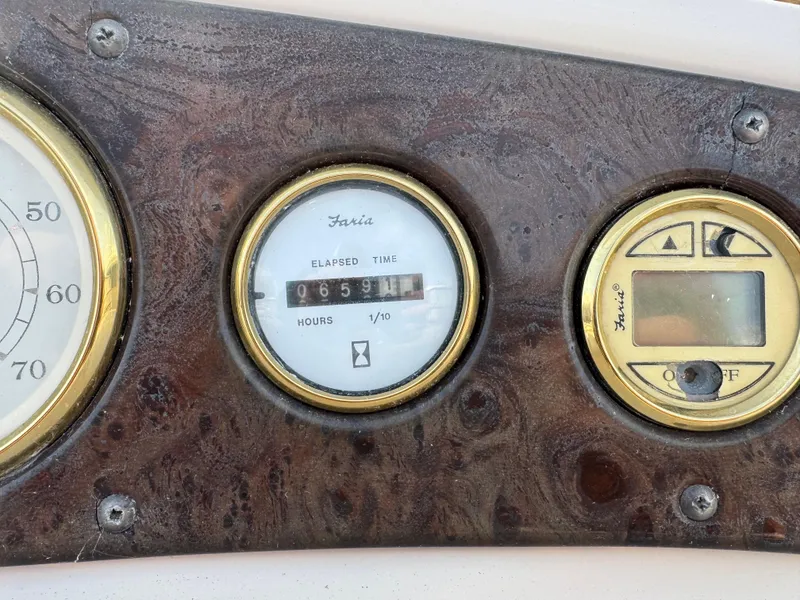 Slide: The Image of Dashboard of 2006 Manitou 24 Legacy boat with elapsed time gauge. - 7