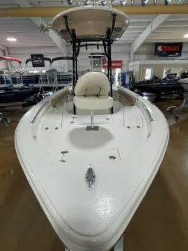 Slide: The Image of 2024 Sea Chaser LX boat in showroom, featuring sleek design and spacious deck. - 3