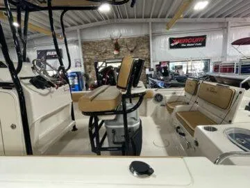 Slide: The Image of 2024 Sea Chaser LX boat interior with seating and equipment in a showroom. - 7