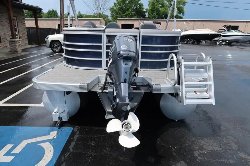 Slide: The Image of 2024 Bennington L Entertainment 23 LPD pontoon boat with outboard motor and ladder. - 12
