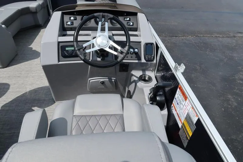 Slide: The Image of 2024 Bennington L Entertainment 23 LPD boat helm with steering wheel and control panel. - 15
