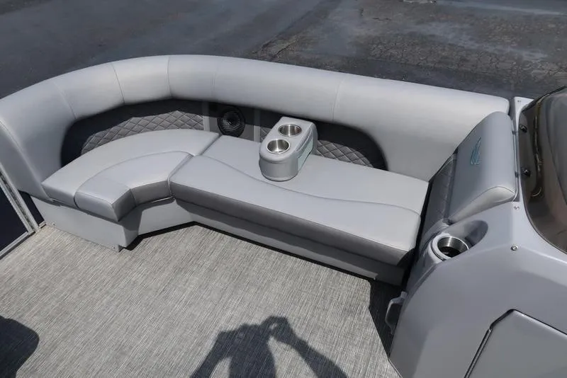 Slide: The Image of 2024 Bennington L Entertainment 23 LPD boat interior with gray seating and cup holders. - 25