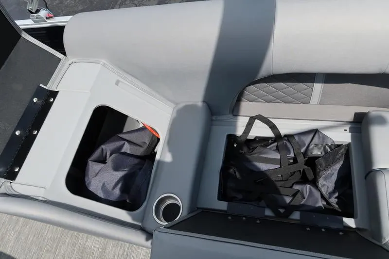 Slide: The Image of 2024 Bennington L Entertainment 23 LPD boat storage compartments with cup holder and bags. - 29