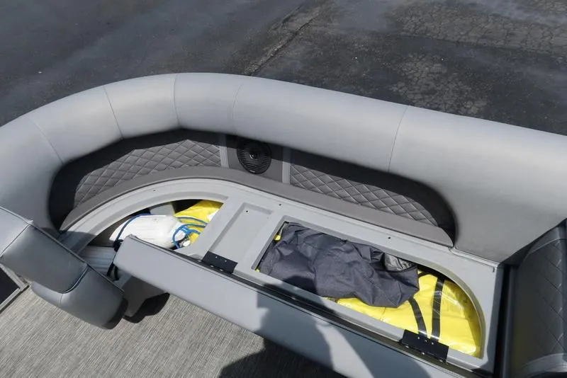 Slide: The Image of 2024 Bennington L Entertainment 23 LPD boat seating with storage compartment open. - 30