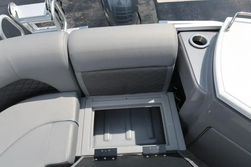 Slide: The Image of 2024 Bennington L Entertainment 23 LPD boat interior with storage compartment and cup holder. - 33