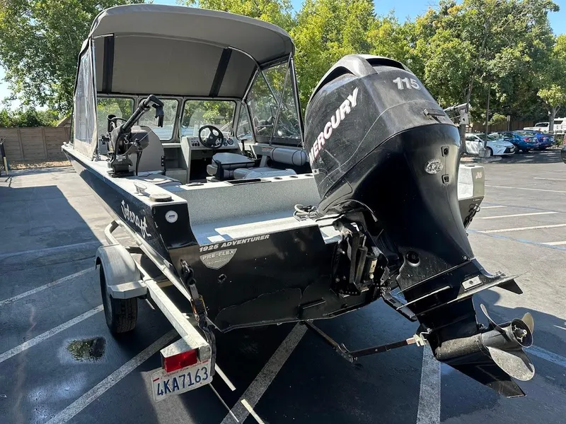 Slide: The Image of 2008 Jetcraft 1925 Adventurer boat with Mercury 115 engine in a parking lot. - 10