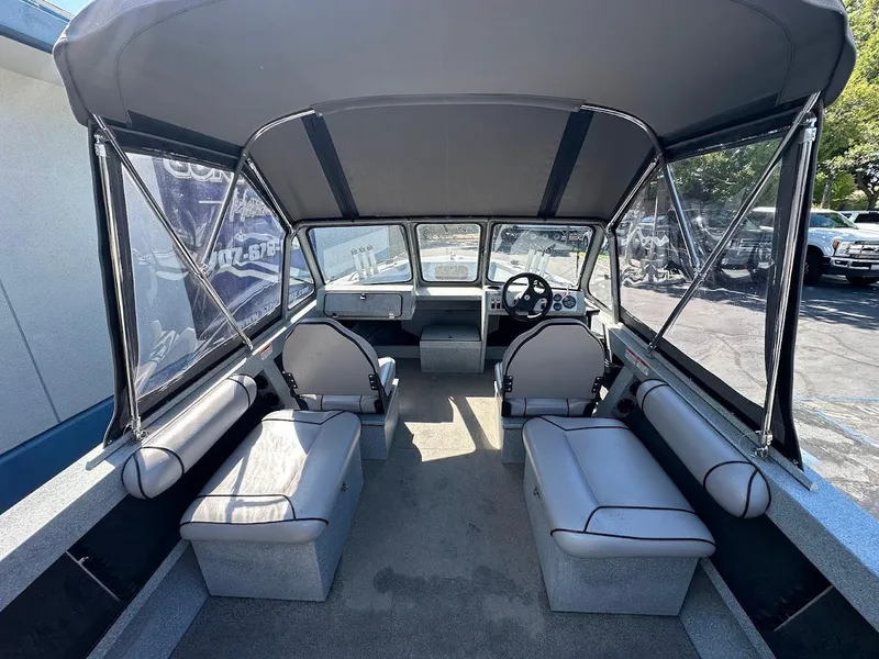 Slide: The Image of Interior of 2008 Jetcraft 1925 Adventurer boat with seating and steering wheel. - 14