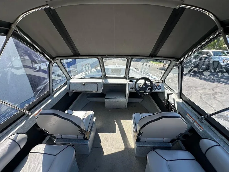 Slide: The Image of Interior of a 2008 Jetcraft 1925 Adventurer boat, featuring seating and steering console. - 15