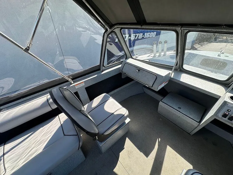 Slide: The Image of Interior of a 2008 Jetcraft 1925 Adventurer boat, featuring seating and dashboard. - 16