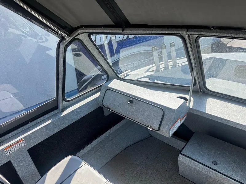 Slide: The Image of Interior of a 2008 Jetcraft 1925 Adventurer boat, featuring seating and dashboard. - 17