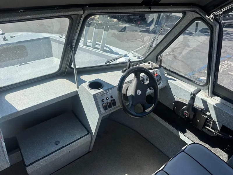 Slide: The Image of Interior of a 2008 Jetcraft 1925 Adventurer boat, featuring steering wheel and control panel. - 18