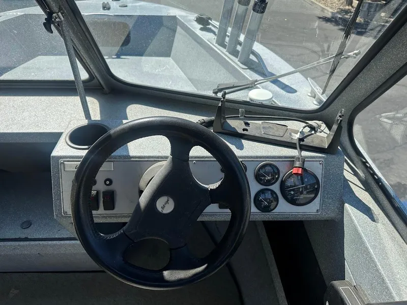 Slide: The Image of Jetcraft 1925 Adventurer 2008 boat dashboard with steering wheel and gauges. - 19