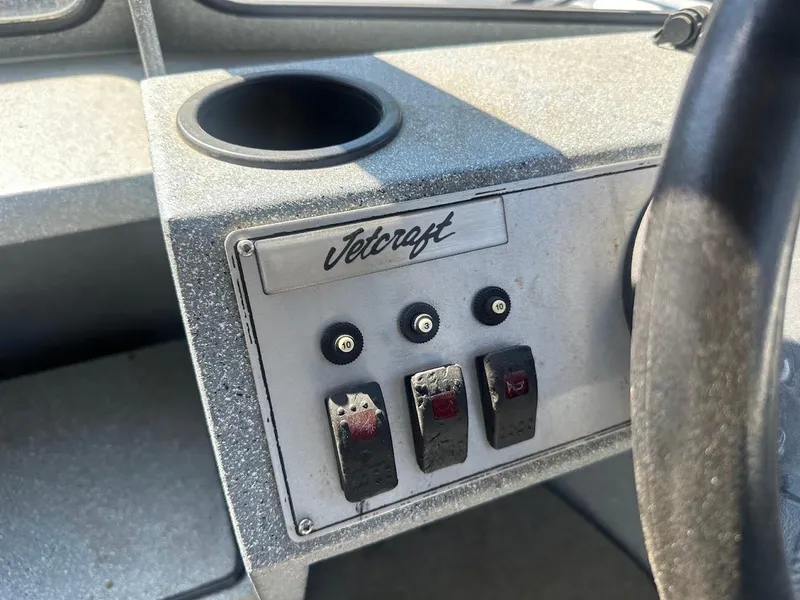 Slide: The Image of Control panel of a 2008 Jetcraft 1925 Adventurer boat with switches and cup holder. - 20