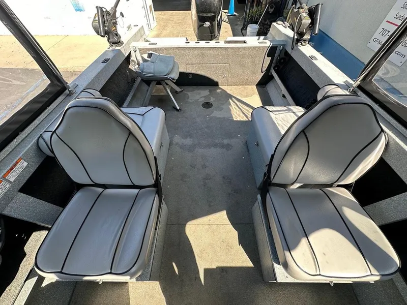 Slide: The Image of Interior of a 2008 Jetcraft 1925 Adventurer boat with gray seating and fishing equipment. - 22