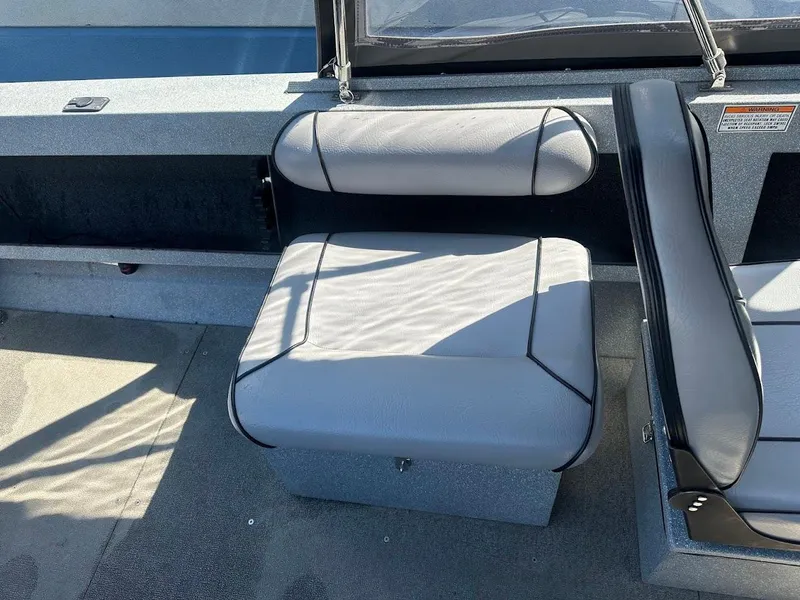 Slide: The Image of Jetcraft 1925 Adventurer 2008 boat interior with gray seating and storage compartment. - 23