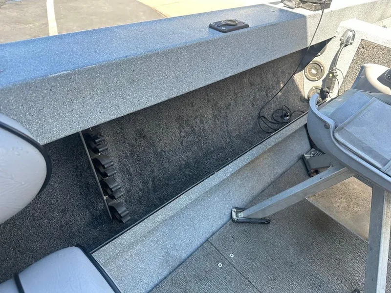 Slide: The Image of Interior of a 2008 Jetcraft 1925 Adventurer boat, featuring seating and storage. - 27