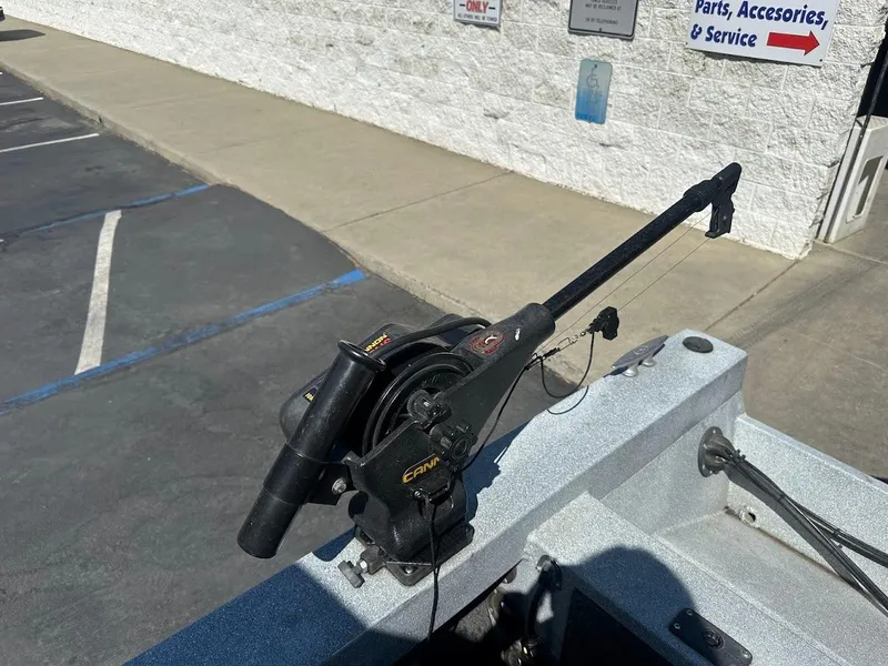 Slide: The Image of Boat-mounted fishing downrigger on a 2008 Jetcraft 1925 Adventurer, parked near a service center. - 29
