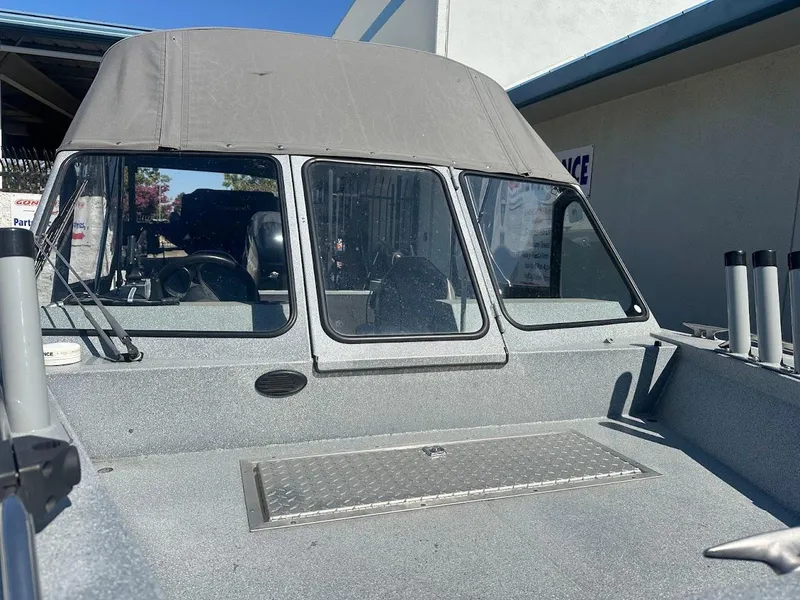 Slide: The Image of Jetcraft 1925 Adventurer boat, 2008 model, with canopy and windshield, parked outdoors. - 34