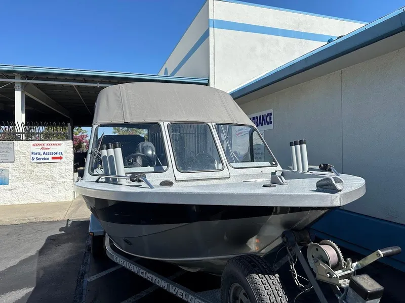 Slide: The Image of Jetcraft 1925 Adventurer boat, 2008 model, parked outside a service center under clear blue sky. - 5
