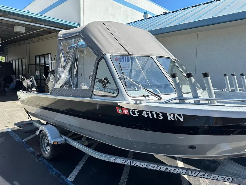 Slide: The Image of Jetcraft 1925 Adventurer 2008 boat on trailer, parked outside building. - 6
