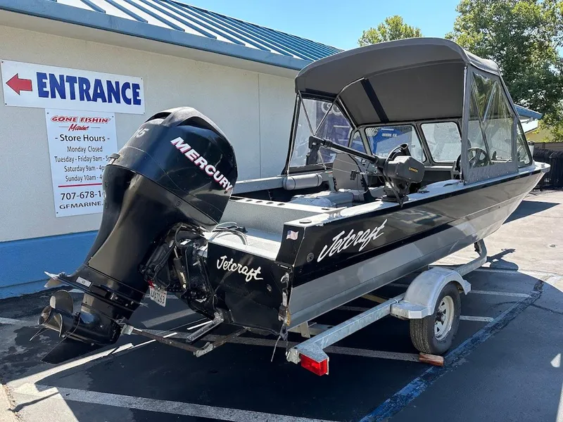 Slide: The Image of 2008 Jetcraft 1925 Adventurer boat with Mercury engine on trailer, parked outside store. - 8