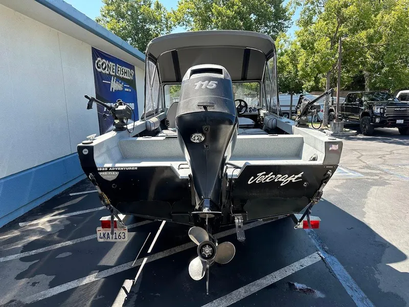 Slide: The Image of Jetcraft 1925 Adventurer boat, 2008 model, parked outdoors with visible motor and propeller. - 9